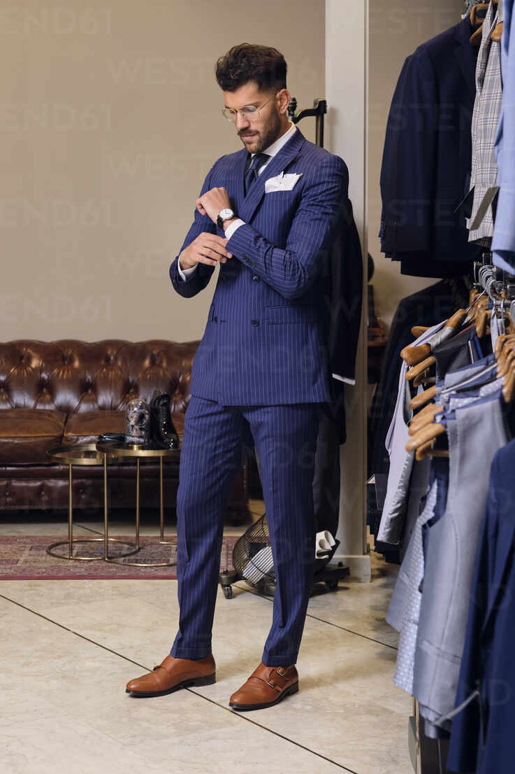 https://us.images.westend61.de/0001502998pw/man-in-blue-pinstripe-suit-in-tailors-boutique-AODF00194.jpg
