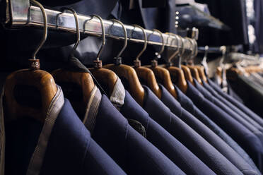 Row of blazers on rack in tailors boutique - AODF00205