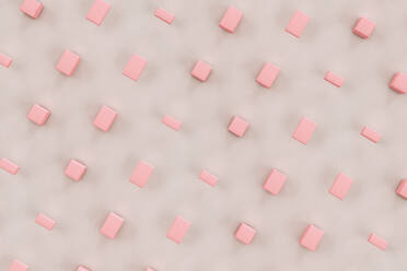 Three dimensional render of pink cuboids floating against gray background - GCAF00046