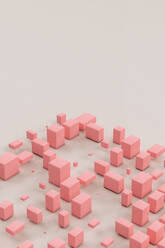 Three dimensional render of pink cuboids floating against gray background - GCAF00049