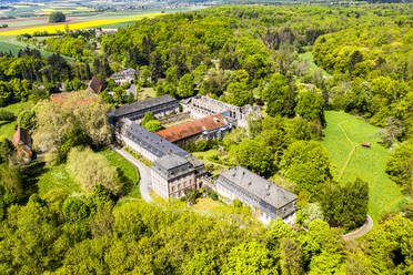 Germany, Hesse, Lich, Helicopter view of Arnsburg Abbey in spring - AMF08944