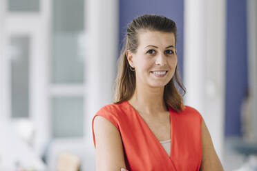 Portrait of smiling businesswoman in office - GUSF04960