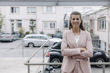 Portrait of businesswoman standing outdoors - GUSF04971