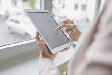 Businesswoman using digital tablet in office - GUSF04989