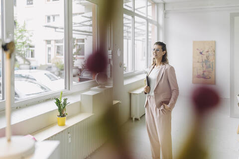 Businesswoman standing in office stock photo