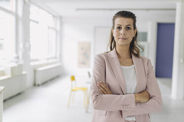 Portrait of businesswoman standing in office - GUSF05002