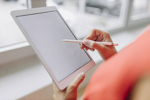 Businesswoman using digital tablet in office stock photo