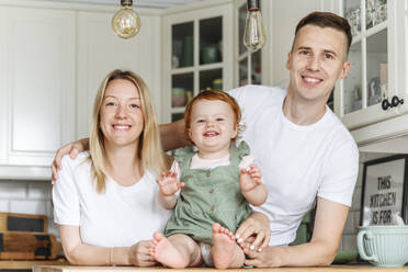 Portrait of happy family with baby daughter at home - VYF00391