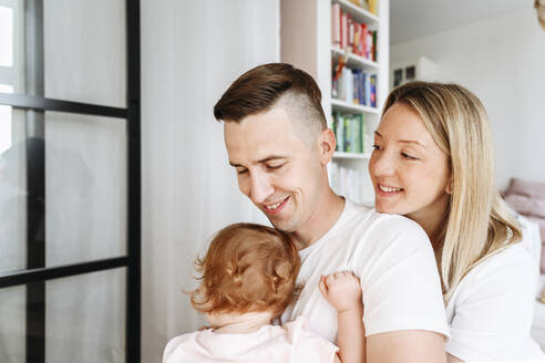 Glückliche Familie mit kleiner Tochter zu Hause - VYF00410