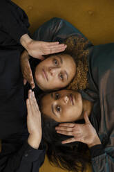 Porträt eines lesbischen Paares, das zusammen auf einem Sofa liegt - AXHF00082