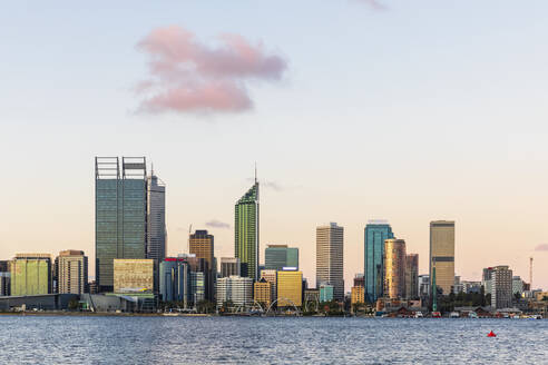 Australia, Perth, Downtown skyscrapers seen across Swan river at sunset - FOF11877