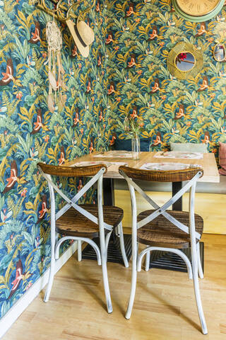 Interior of empty restaurant with floral wallpaper stock photo