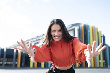 Portrait of beautiful brunette reaching toward camera - JCCMF00745