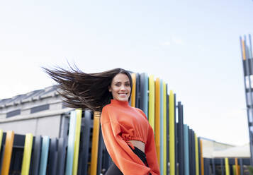 Portrait of beautiful brunette tossing hair - JCCMF00750