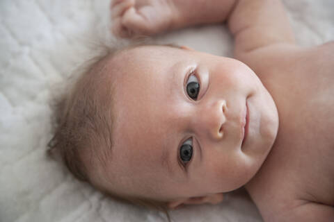 Baby boy lying on back stock photo