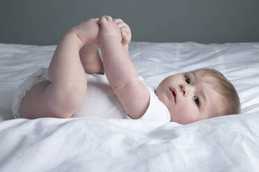 Baby boy lying on bed - ISPF00014