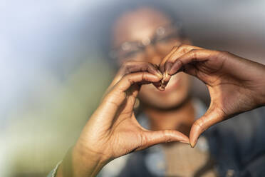 Hands of woman showing heart sign - WPEF03928