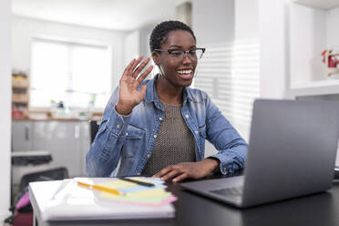 Woman working having video call via laptop at home - WPEF03937