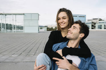 Smiling couple embracing in city - XLGF00974