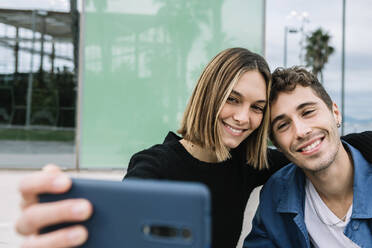 Lächelndes Paar nimmt Selfie im Freien - XLGF01006