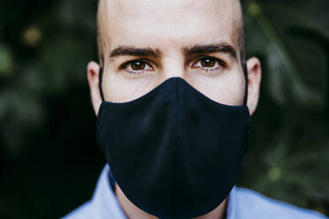 Young man wearing protective mask - EBBF02176