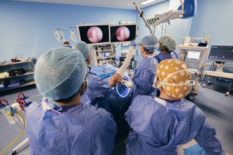 Doctor analyzing endoscope on computer monitor while standing at operating room stock photo