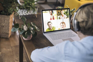 Senior woman having video conference with family at home - UUF22653
