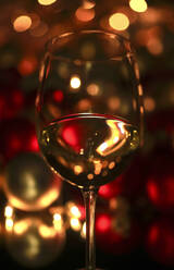 Wineglass reflecting Christmas lights - JTF01786