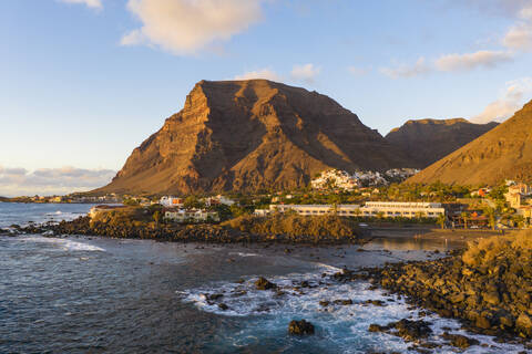 Town and mountain on island surrounded with sea stock photo