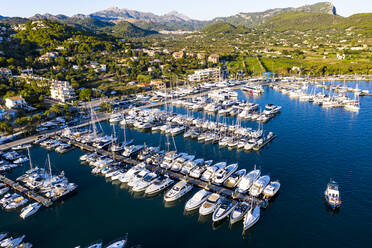 Spain, Balearic Islands, Andratx, Helicopter view of boats moored in harbor of coastal town - AMF08960