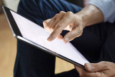 Close-up of businessman using digital tablet - PESF02536