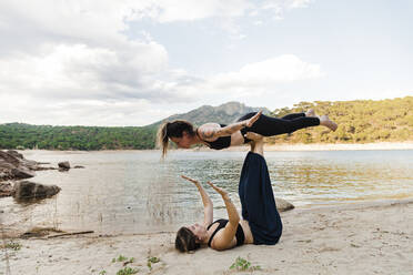 Young female friends doing acroyoga - MRRF00809