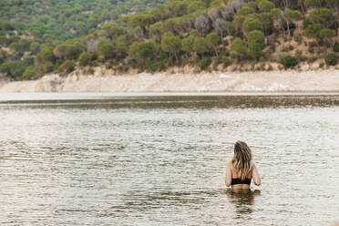 Young woman bathing in lake - MRRF00813