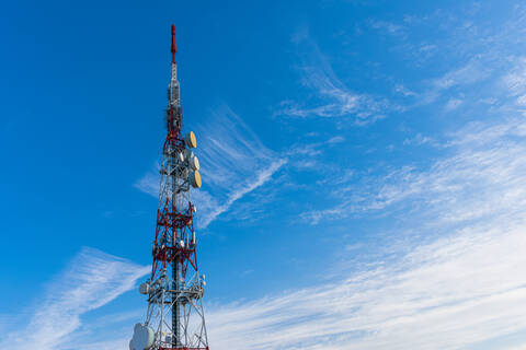 Radio communication antenna on blue sky background stock photo