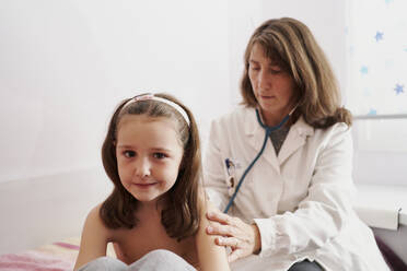 Pediatric doctor examine little happy girl with stethoscope. Chi - CAVF91806