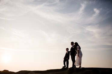 Newlyweds & Nine Year Old Son Standing on Rock at Beach in San Diego - CAVF91818