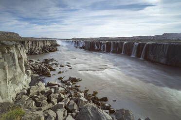 Scenic view of Selfoss waterfall on Jokulsa a Fjollum river against sky, Northern Iceland - CAVF91870