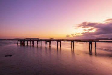 Silhouette of jetty on shore of Shoal Bay at moody dawn - FOF11932