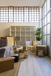 Interior of new apartment with stack of books - GIOF10699