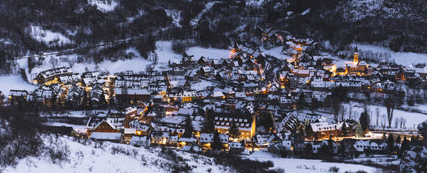 Spain, Cataluna, Baqueira, Ski resort covered with snow illuminated at dusk - JAQF00186