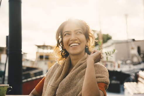 Smiling woman looking away in houseboat - MASF21327