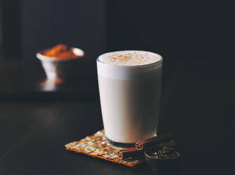 Glass of chai latte with cinnamon - PPXF00340