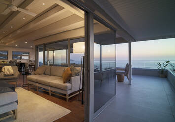 Luxury home showcase living room and balcony with scenic ocean view - CAIF30213