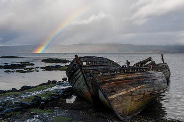 Rainbow and beached old wooden fishing boats on shore at Salen - MINF15719