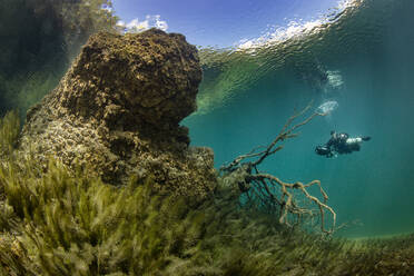 Austria, Tyrol, Lake Fernsteinsee, Scuba diver in lake - YRF00271