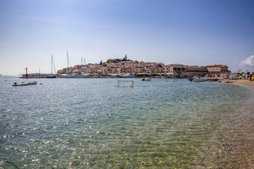 Beach against Primosten townscape at Sibenik-Knin, Croatia - MAMF01568