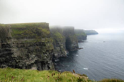 Cliffs of Moher by sea against cloudy sky at Clare, Ireland - BIGF00076