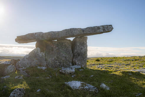 Poulnabrone dolmen on land against blue sky during sunny day, Clare, Ireland - BIGF00077