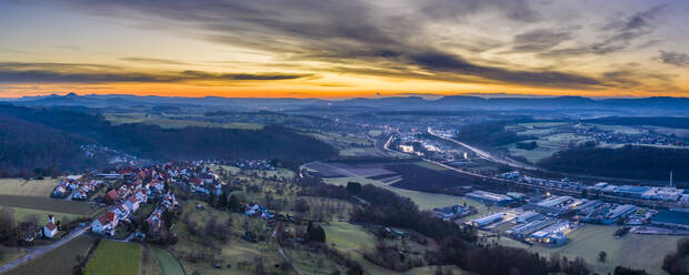 Town against dramatic sky during sunrise - STSF02769