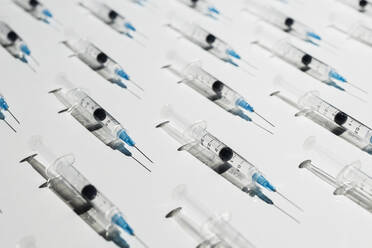 COVID-19 vaccine syringes on white background - FSIF05598